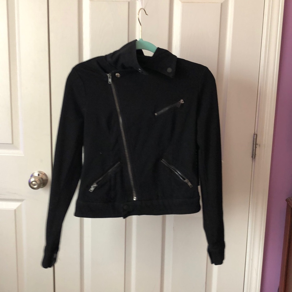 This is a black pea coat with multiple zippers